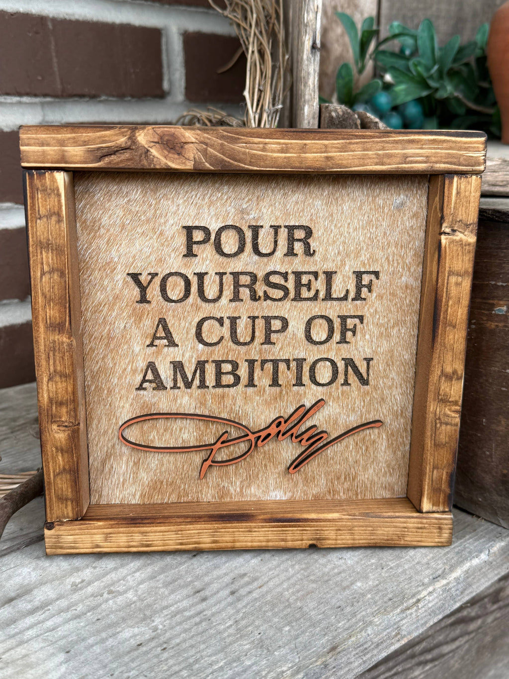 DOLLY PARTON FRAMED COWHIDE SIGN - POUR YOURSELF A CUP OF AMBITION!