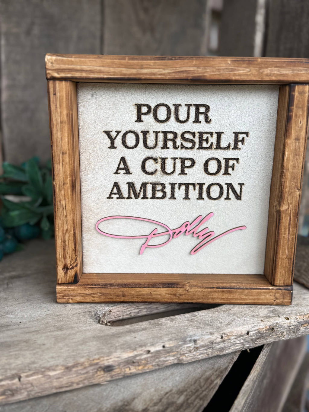 DOLLY PARTON FRAMED COWHIDE SIGN - POUR YOURSELF A CUP OF AMBITION!